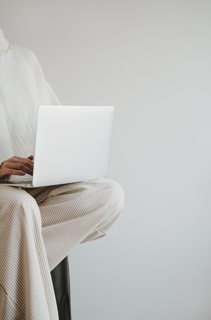 Working on a laptop in a calm, neutral space