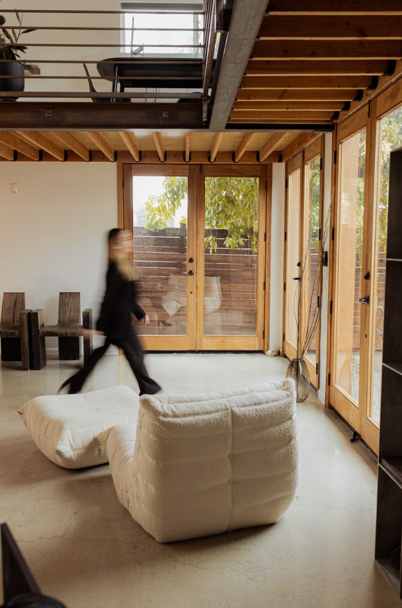 Residential interior — loft living space with wood-framed doors and exposed beams